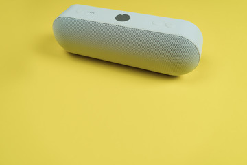 portable speaker on yellow color background