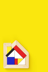House-shaped puzzle placed in the lower left of vertical format. Yellow background with copy space, flat layout.
