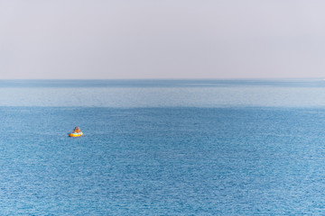 Tiny Fishing Boat on the Southern Italian Mediterranean Sea at Sunrise