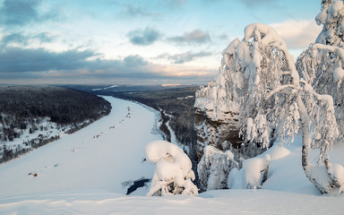 View from a high mountain on a frozen river and endless forests