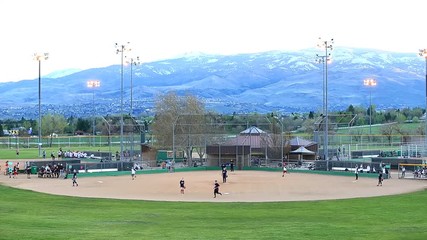 Softball Players on Field in Reno Nevada - Shallow Depth of Field. - Powered by Adobe