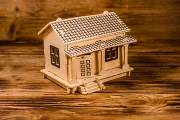 Obraz na płótnie Canvas Plywood model of the house on wooden table