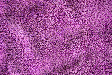 Lilac delicate soft background of fur plush smooth fabric. Texture of purple soft fleecy blanket textile