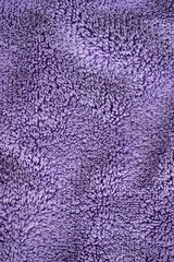 Lilac delicate soft background of fur plush smooth fabric. Texture of purple soft fleecy blanket textile