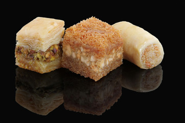 Middle eastern, Turkish sweet pastry baklava isolated on black background