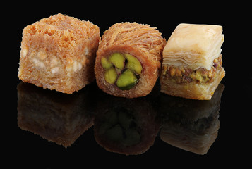 Middle eastern, Turkish sweet pastry baklava isolated on black background
