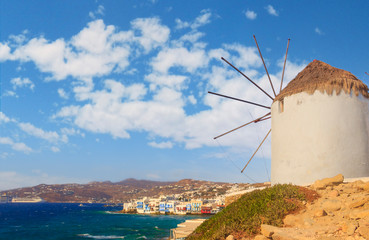 White famous windmills overlooking Little Venice and Mykonos old town, Mykonos, Cyclades, Greece.	