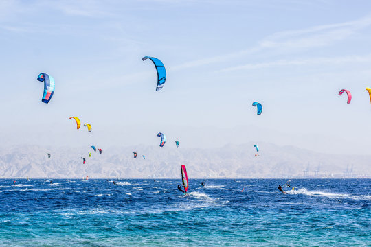 Wind surfers sea activities concept photography near coral beach in Eilat city in south Israeli waterfront of the Red sea scenic landscape place blue environment