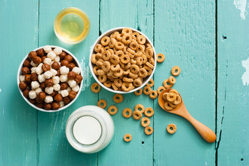 breakfast cereal with milk, honey on blue wood table