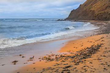 Sea beach with a cape