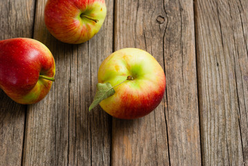 three apples on old wooden background