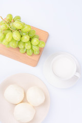 Green Tie and Milk Bread on a White Background