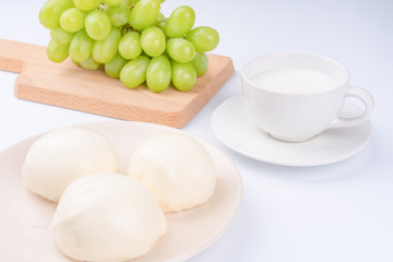 Green Tie and Milk Bread on a White Background