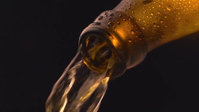 Cinemagraph Loop - Beer Pouring Into Glass On Black Background