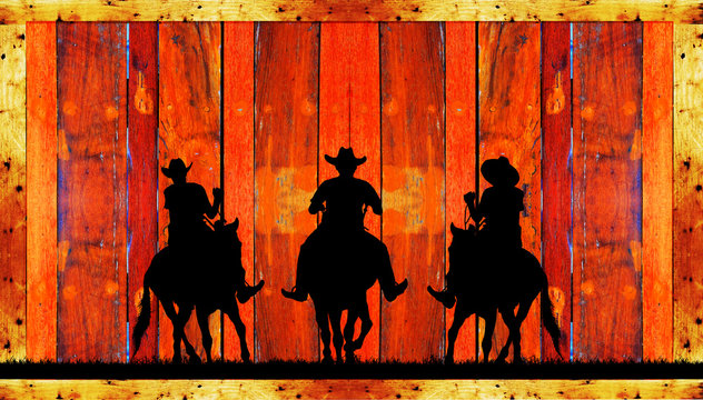 Silhouette of a cowboy riding a wild horse  on a wooden sign