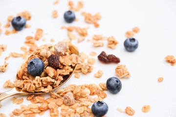 Crispy muesli and blueberry on a spoon Breakfast cereal isolated on white background, selective focus, top view