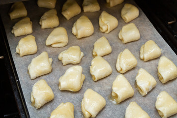 Fototapeta na wymiar Cottage cheese cookies are on a baking sheet before cooking in the oven