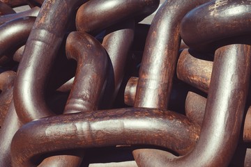 old metallic chain on the ground, brown chain abandoned in the street