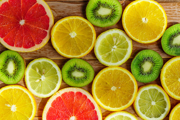 Fototapeta na wymiar frame with slice of oranges, lemons, kiwi, grapefruit pattern isolated on white background.