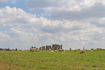 Amesbury, United Kingdom- September 2018, Crowd and Sheep Stand in Front of the Rocks of Stonehenge...
