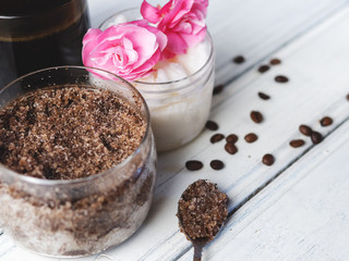 Cup of coffee, coffee scrub with coconut oil on white table