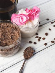 Cup of coffee, coffee scrub with coconut oil on white table