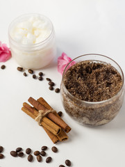 Coffee homemade body scrub with cinnamon, coconut oil and sugar on a white table
