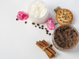 Coffee homemade body scrub with cinnamon, coconut oil and sugar on a white table
