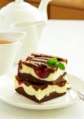Brownie with raspberries. light background.