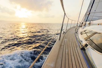 Fototapeten Yacht segelt dem Sonnenuntergang entgegen © Plamen