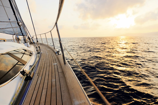 Yacht sailing towards the sunset