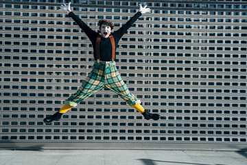 Mime happy gesticulating and jumping in the street