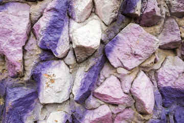 Textured stone wall. Paint on the concrete surface.