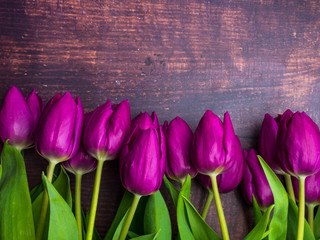 Fototapeta na wymiar Beautiful purple flowers tulips on old wooden background