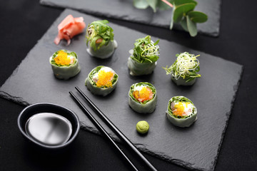 Spring rolls, sushi rolls with salmon, rucola, philadelphia cheese.