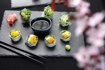 Spring rolls, sushi rolls with salmon, rucola, philadelphia cheese.