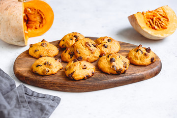 Pumpkin cookies with chocolate chips made from cake mix on a wooden tray.
