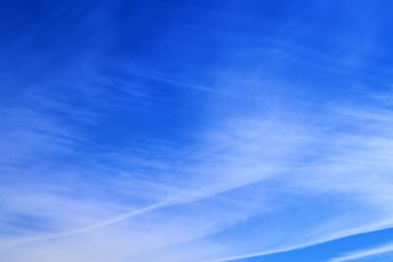 Beautiful white cirrus clouds high in a deep blue sky