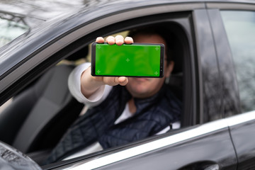 Man hold smartphone in car