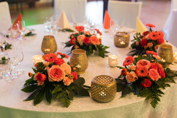 Udekorowane kwiatami i ozdobami stoły na uroczystości rodzinne takie jak wesela - obrazy, fototapety, plakaty