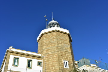 Obraz premium Finisterre lighthouse with blue sky, final stage of Camino de Santiago. Spain.