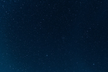 Night blue sky with stars. The texture of a blue sky with stars.