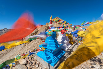 Buddhist white,blue and yellow stupa and prayer flag in lalunga pass in Leh , Ladakh, India . l\Lalunga is tallest road in the world