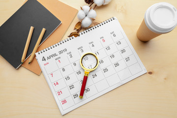Magnifying glass and calendar,Concept in business and meetings