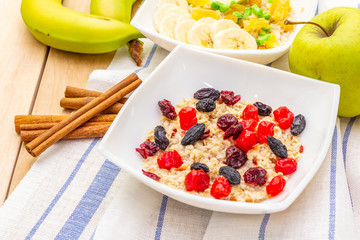 Healthy vegetarian (vegan) breakfast with oatmeal and fruits.