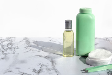 Cosmetic bottle with liquid for cleansing face or make up remover on marble background. Natural organic skin care beauty products.