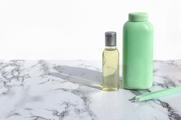 Cosmetic bottle with liquid for cleansing face or make up remover on marble background. Natural organic skin care beauty products.
