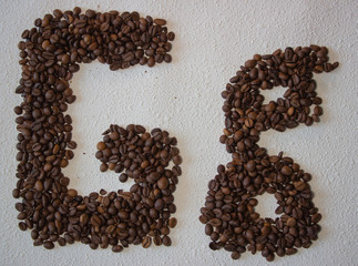 Image of roasted coffee beans shaped alphabet on a white background