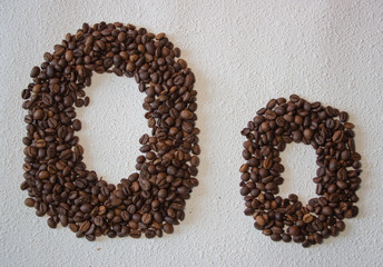 Image of roasted coffee beans shaped alphabet on a white background