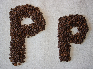Image of roasted coffee beans shaped alphabet on a white background
